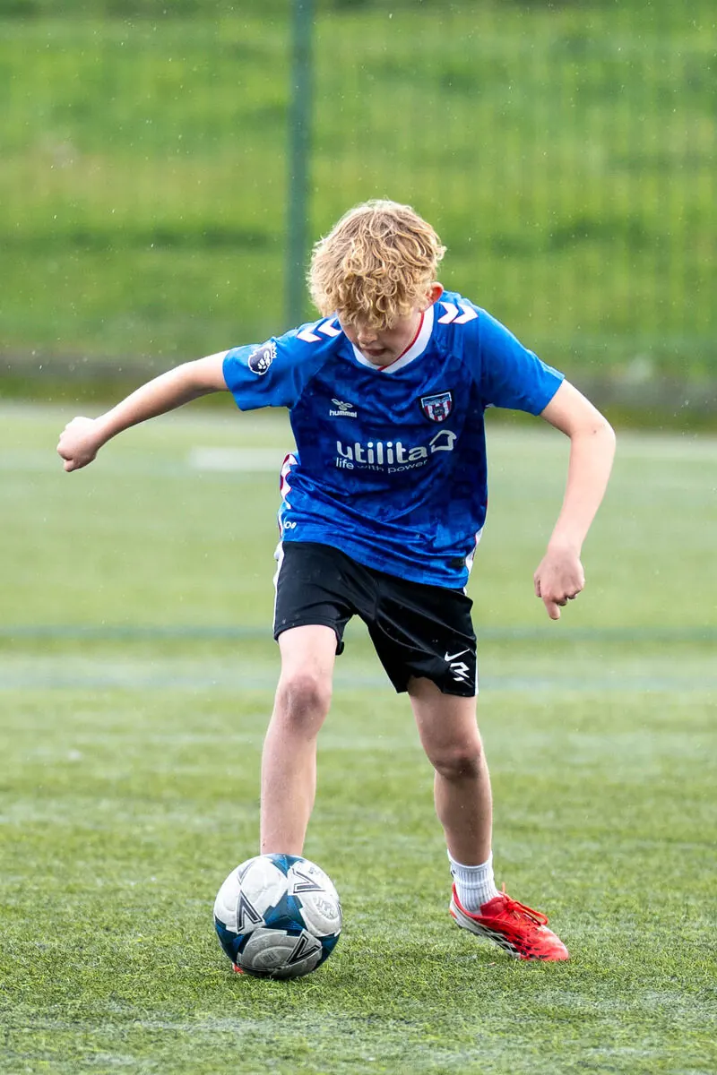 Young footballer kicking the ball