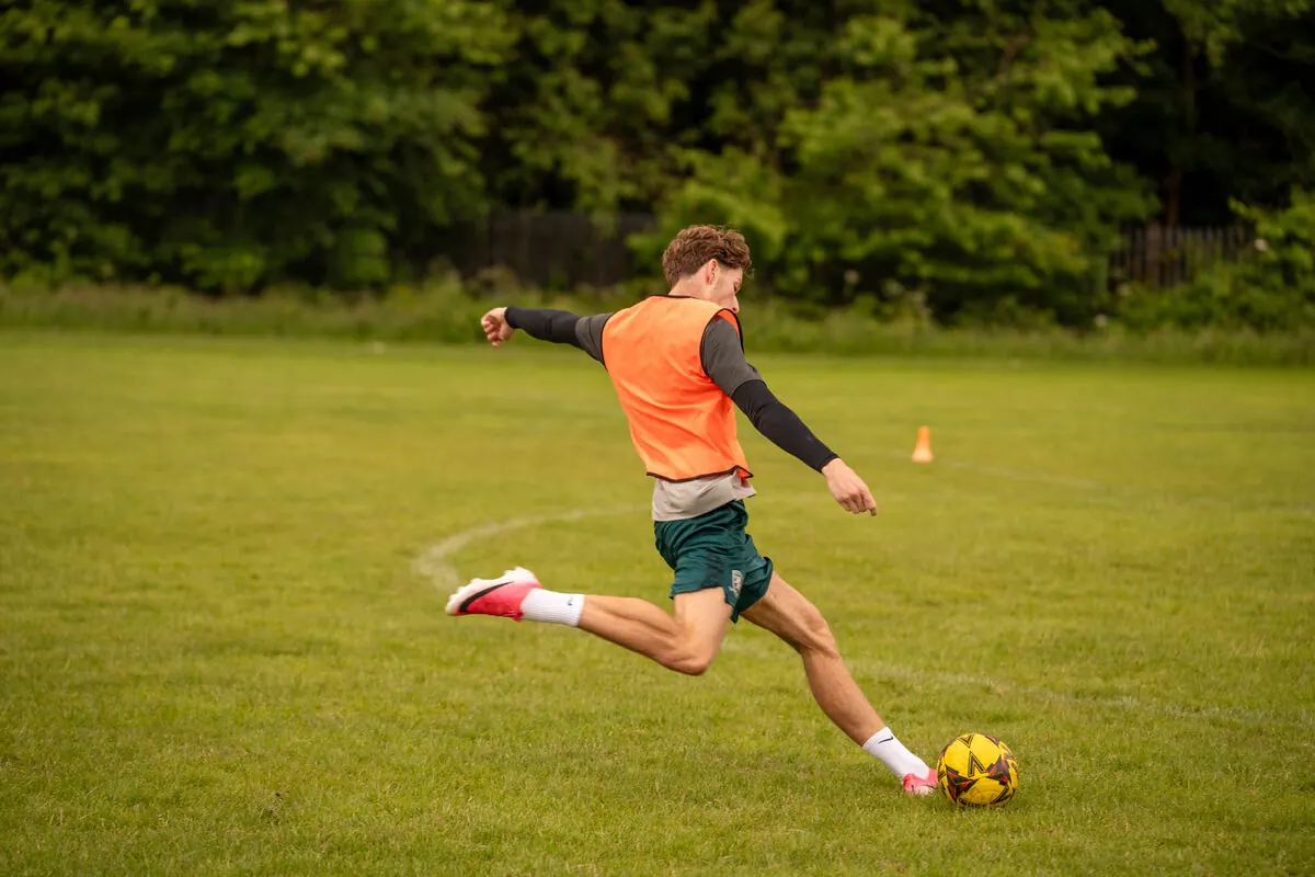 Player striking a ball at a pro camp